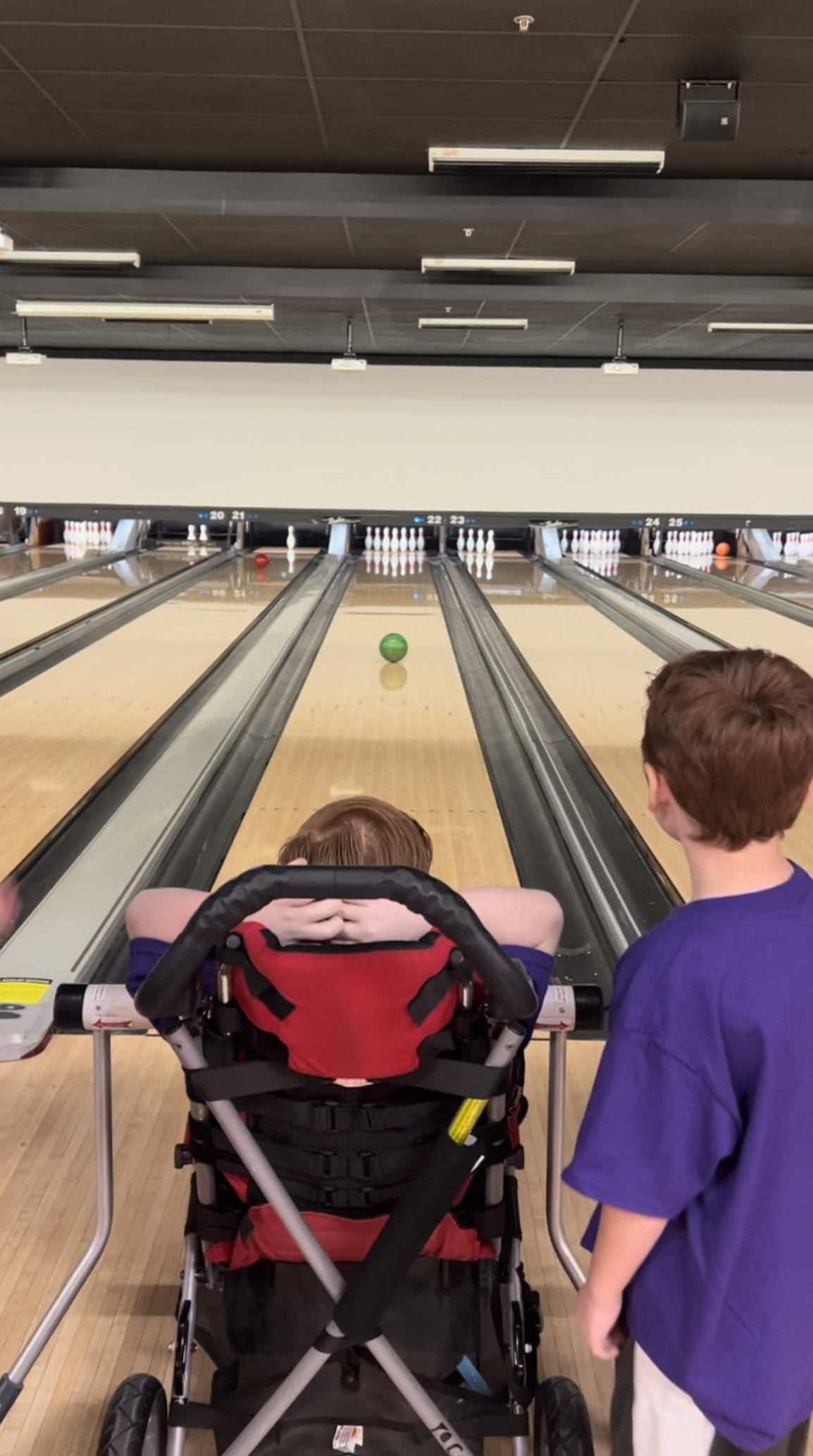 student bowling with brother